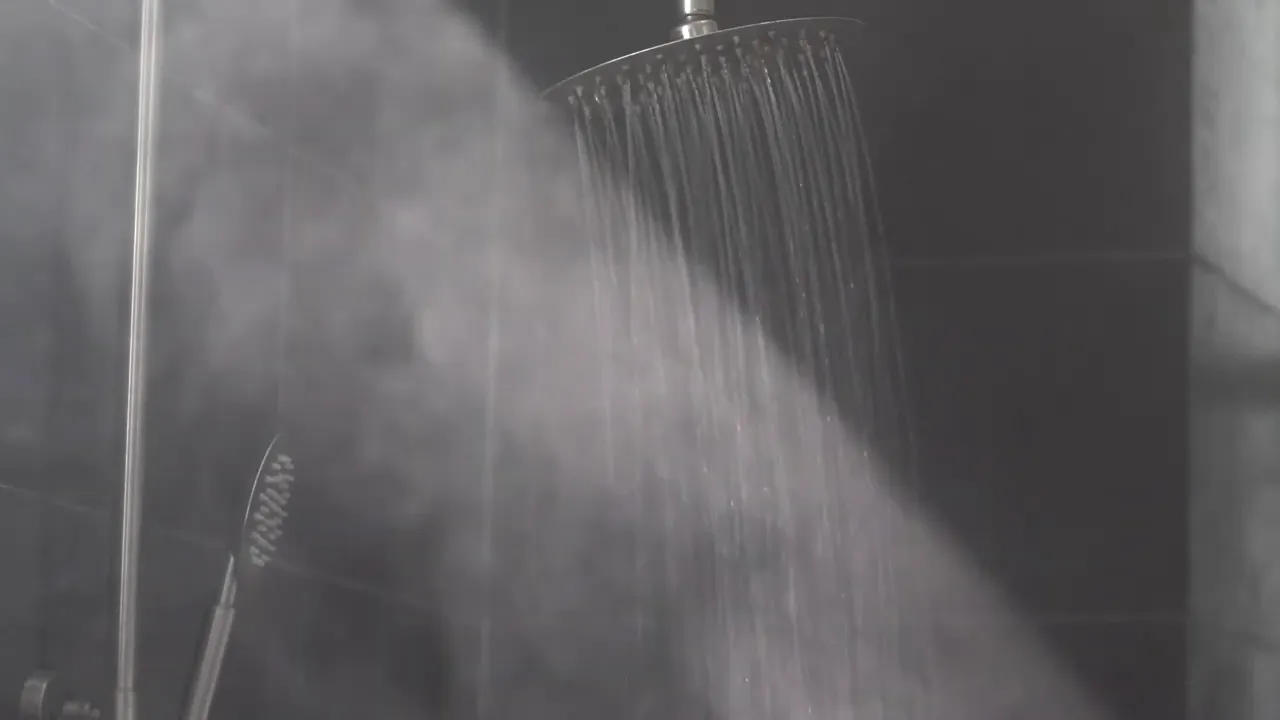 shower head spraying steaming hot water
