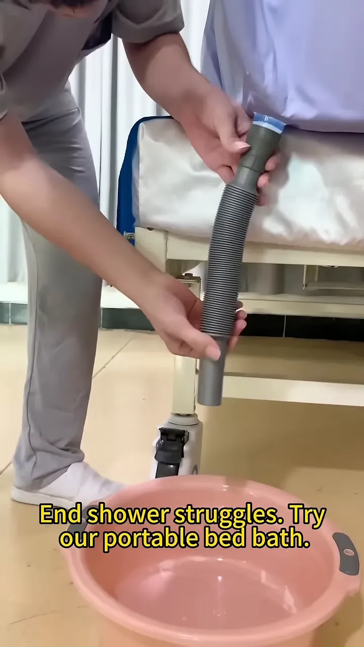 drain hose extended from the side of a bed into a pink basin on the floor