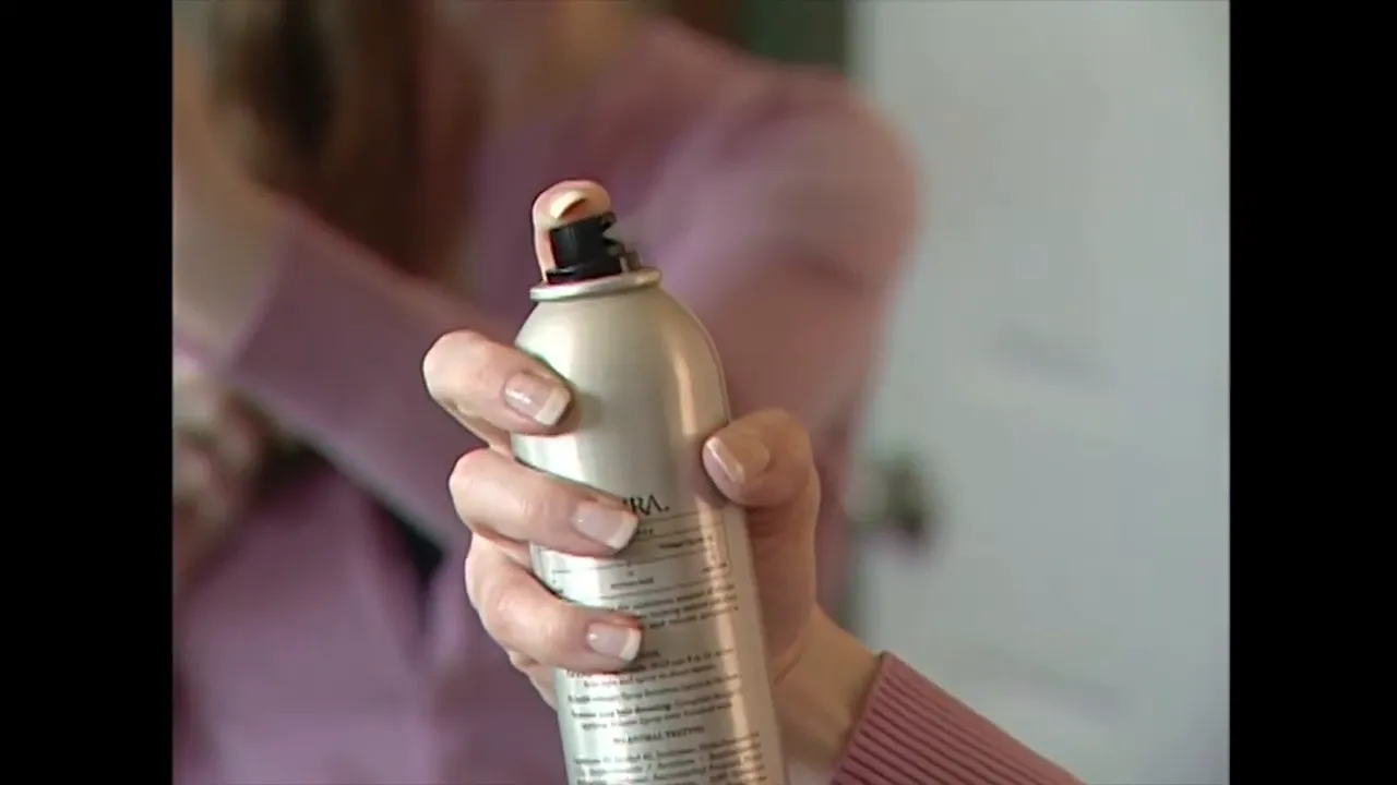 close-up of an aerosol spray can being pressed