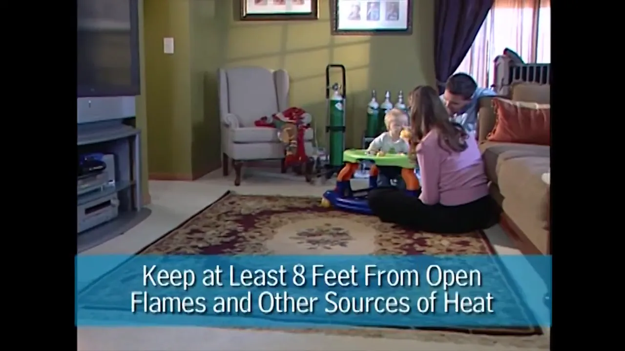 living room scene with oxygen tanks and on-screen text about keeping at least 8 feet from open flames and heat