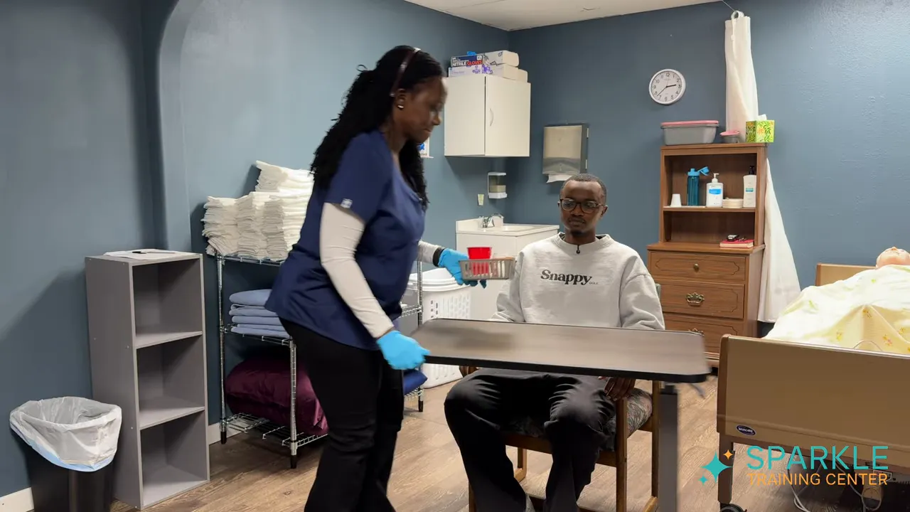 caregiver placing medication supplies and water on an overbed table in front of seated client