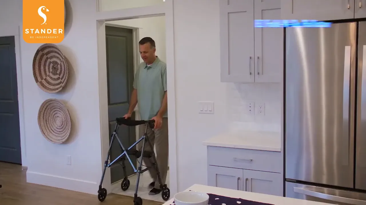 Man entering a kitchen area using a walker