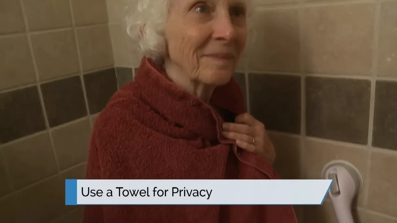 older woman draped in a towel with on screen text use a towel for privacy