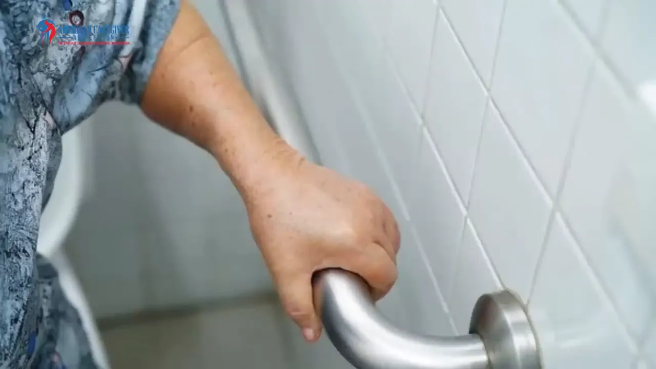 hand gripping a bathroom grab bar mounted on a tiled wall