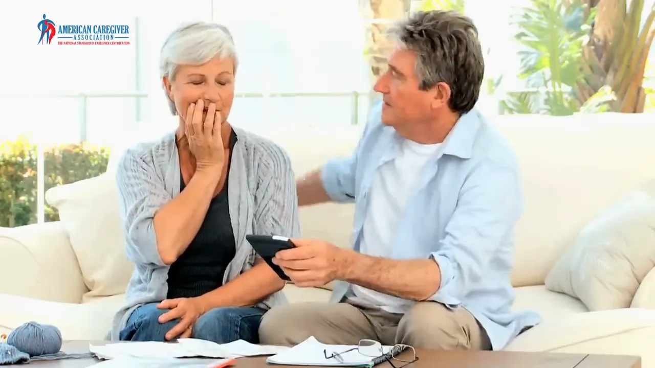 two women sitting on a couch holding hands in conversation