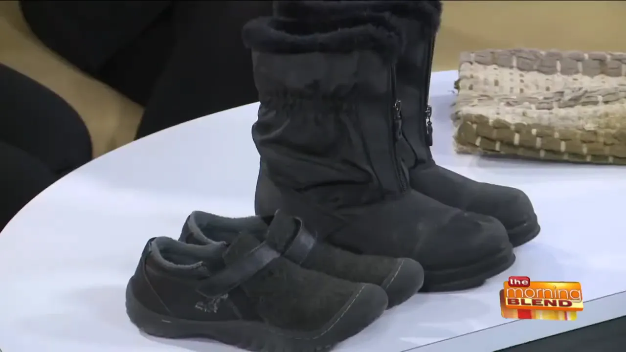 pair of black winter boots and black shoes on a white table with a rug in the background