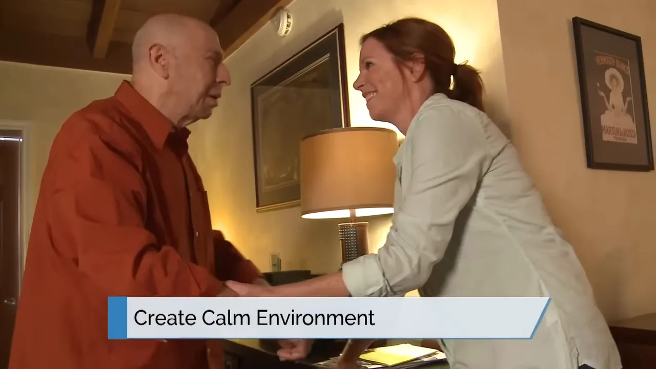 caregiver gently holding an older man's hands with on-screen text create calm environment