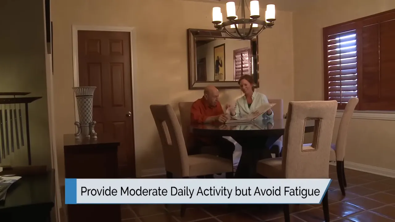 older man and caregiver seated at dining table with on-screen text provide moderate daily activity but avoid fatigue