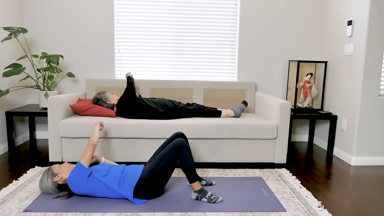 Two exercisers lying on their backs alternating side punches with bent elbows and fists