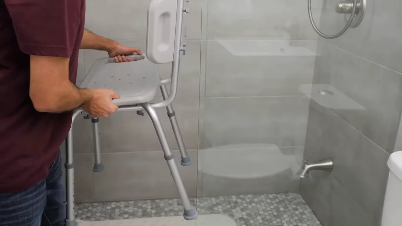 person placing a shower chair inside a tiled shower