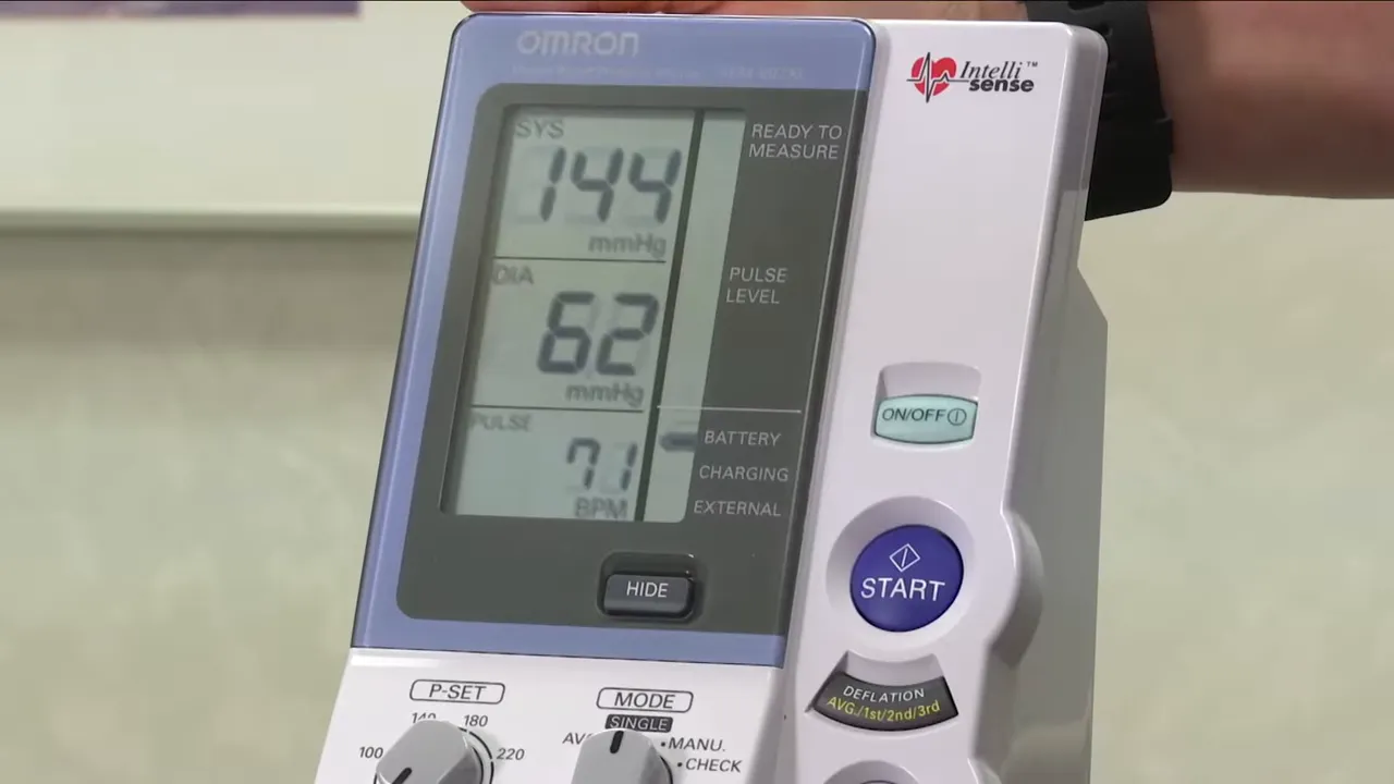 digital blood pressure monitor displaying 144 over 62 with pulse 71