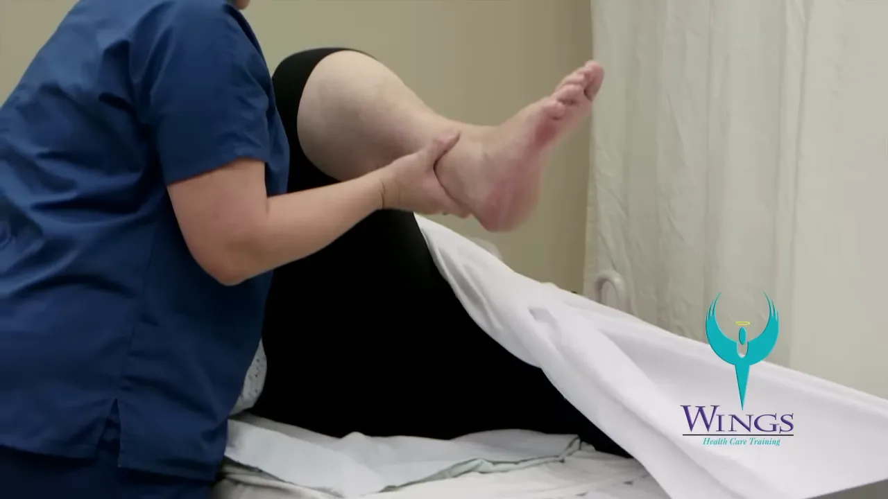 caregiver lifting and bending a patient's leg at the knee on a bed