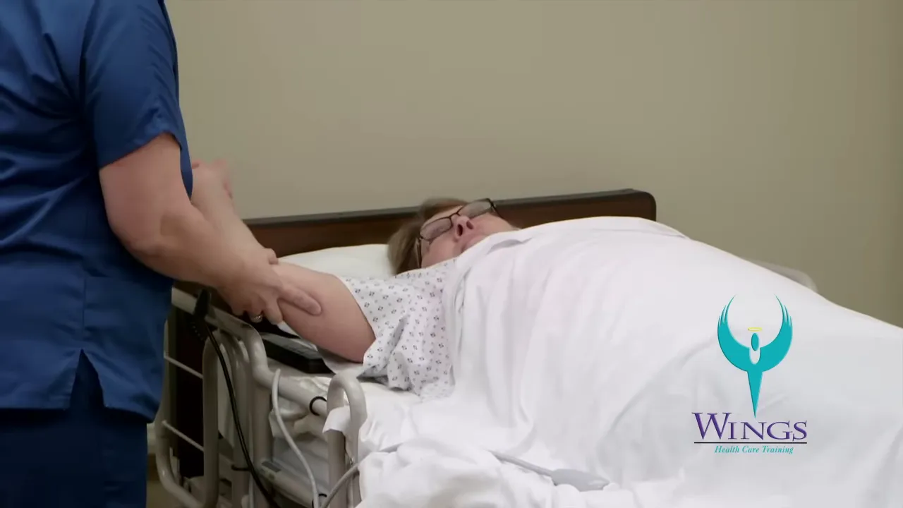 caregiver supporting a patient's bent arm while rotating the shoulder