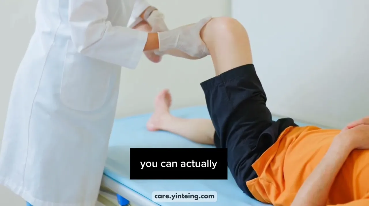 clinician in white coat assisting with a leg movement exercise on a treatment bed