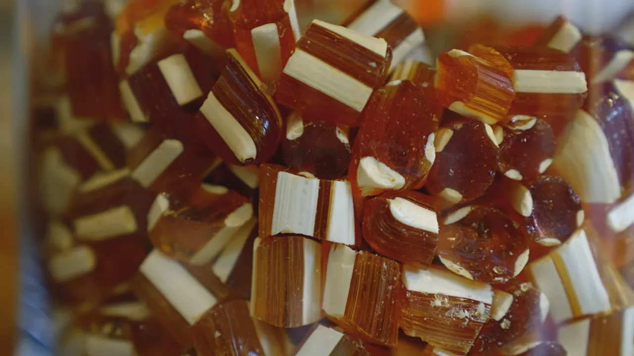 close-up of amber hard akide candies with white centers in a jar
