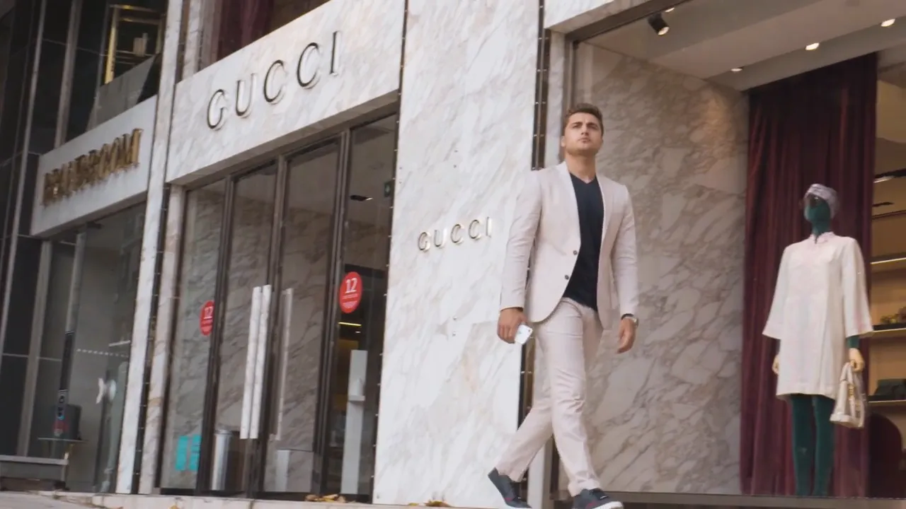 Gucci store entrance with a well-dressed pedestrian walking by, illustrating Nişantaşı's upscale fashion scene.