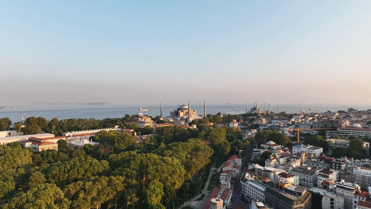 Aerial view of Istanbul skyline showing Hagia Sophia, mosques, and the Bosphorus at sunset