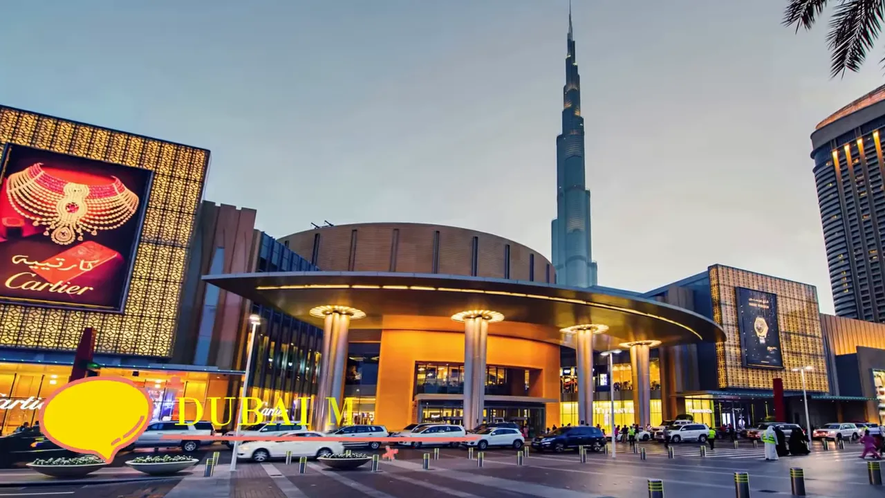 The Dubai Mall main entrance at dusk with vehicles outside and the Burj Khalifa visible in the background.