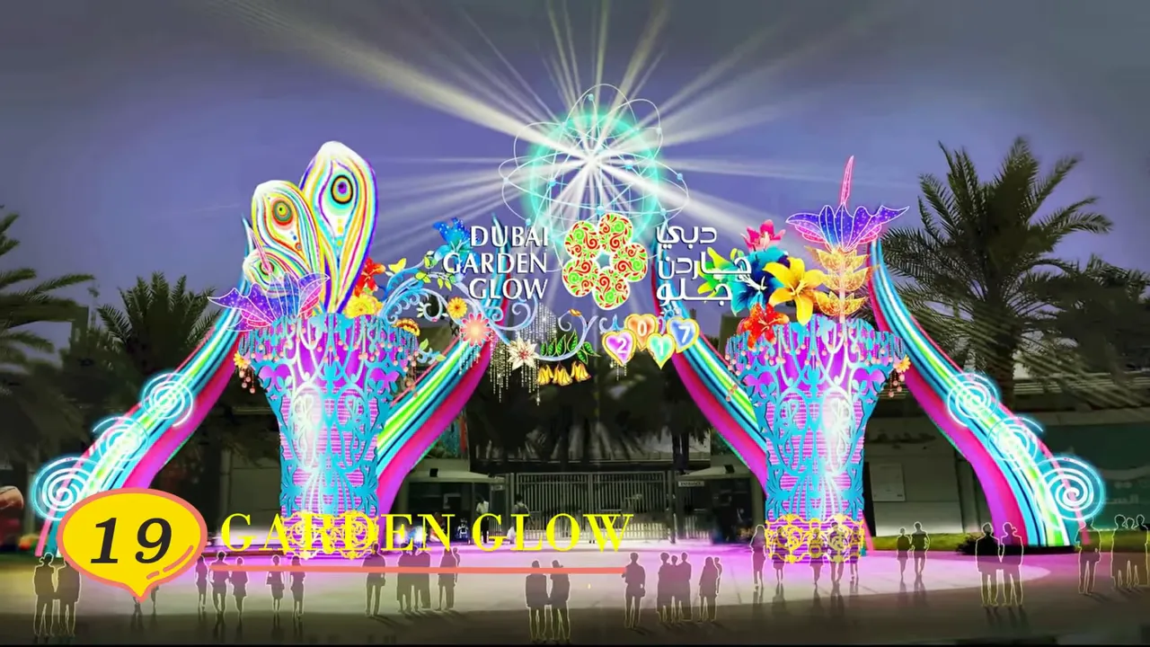 Wide view of Dubai Garden Glow's luminous entrance with decorative towers, lights and visitors (labeled 19)