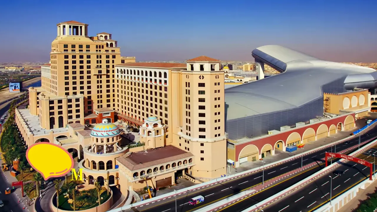 Aerial view of Mall of the Emirates showing Ski Dubai&rsquo;s distinctive silver indoor ski slope roof and adjacent hotel buildings.