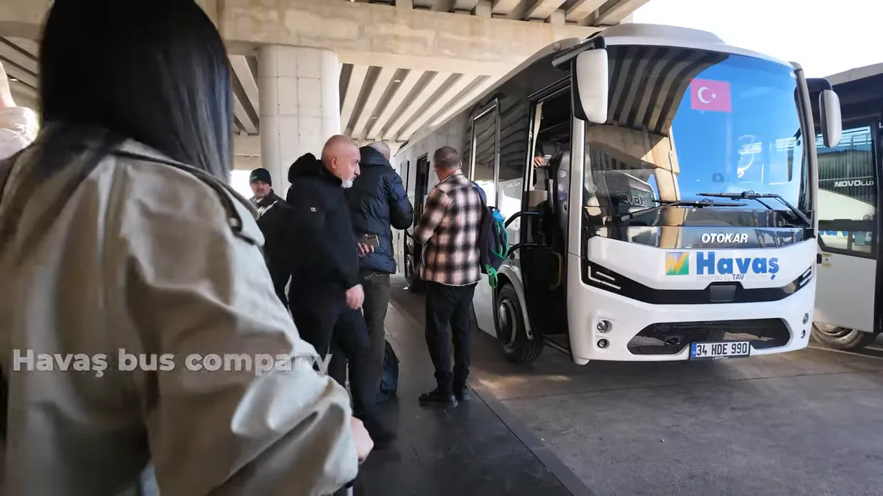Passengers boarding a Havaş airport shuttle bus at the terminal