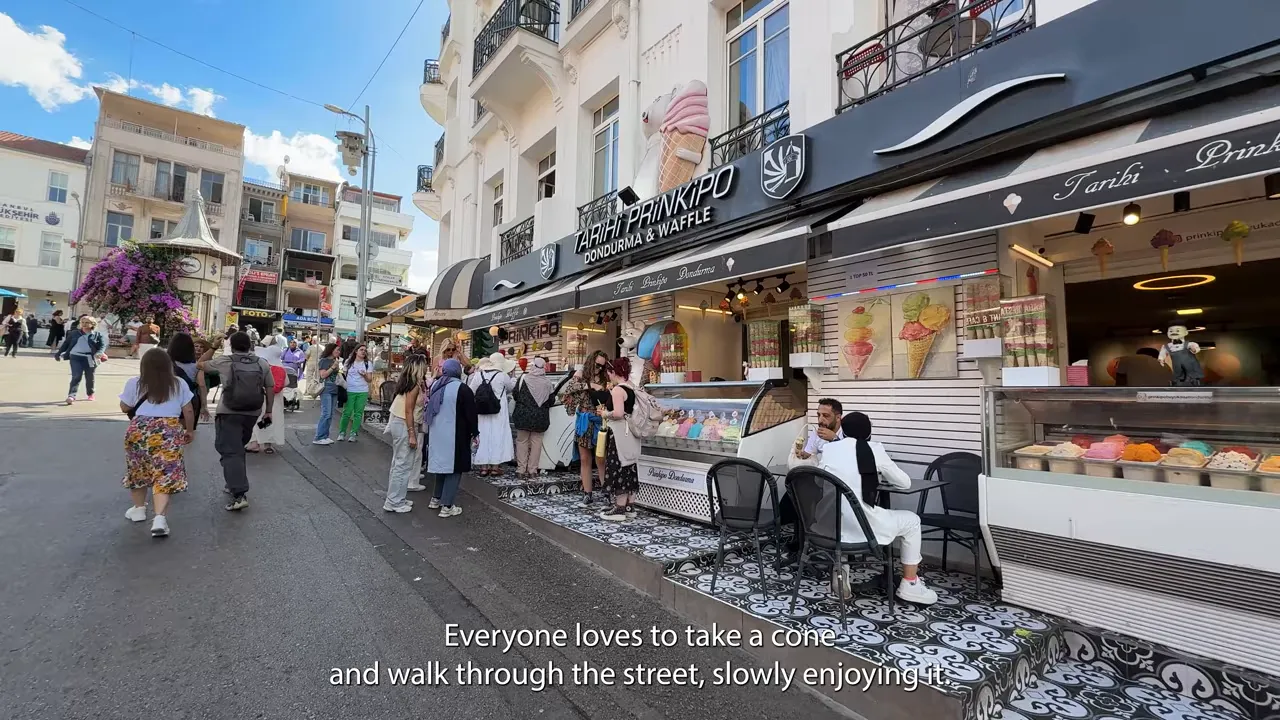 People lined up outside an ice cream kiosk on B&uuml;y&uuml;kada walking and enjoying cones