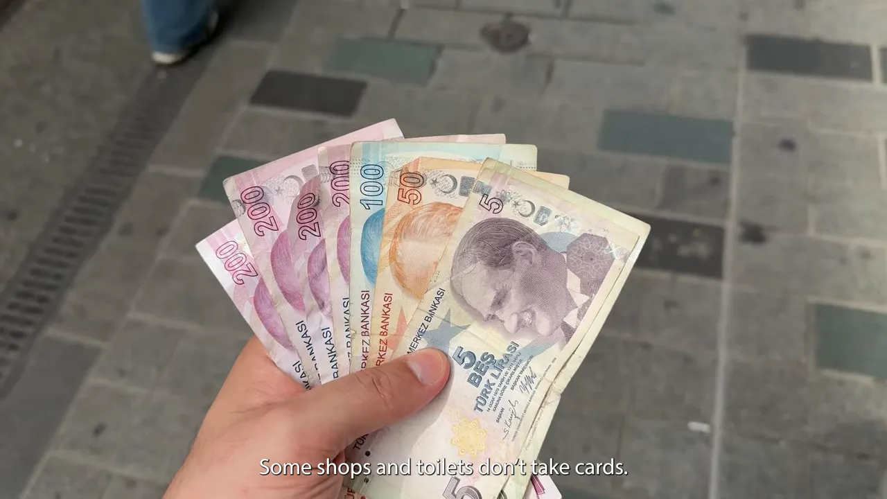 Hand holding Turkish lira banknotes with the caption about not taking cards