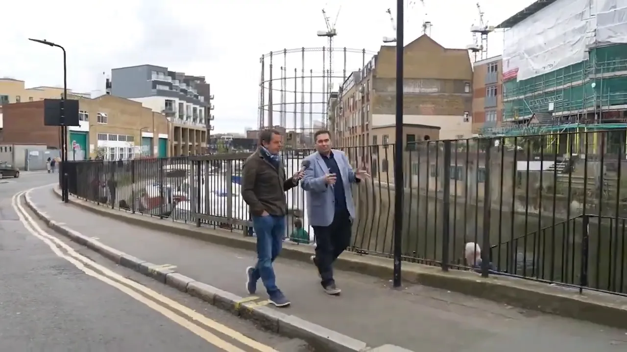 Sunucu ve konuk kanal kenarında y&uuml;r&uuml;yerek b&ouml;lgenin regenerasyonunu anlatıyor.