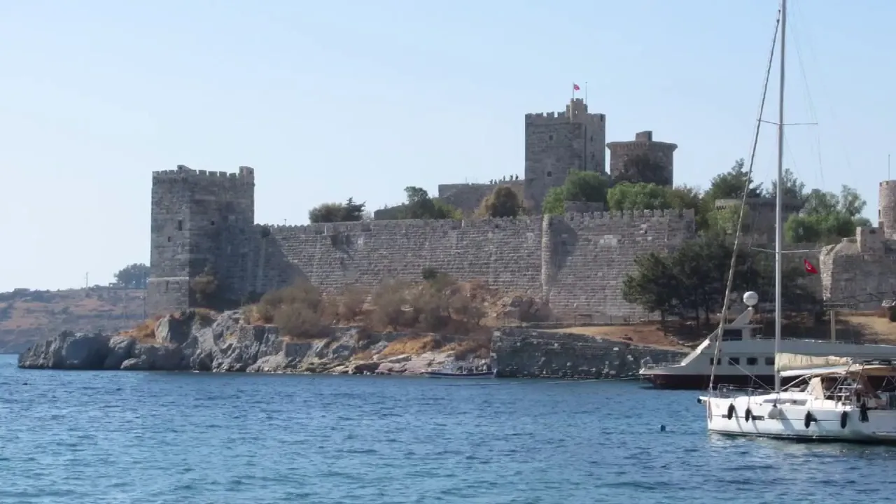 Bodrum Castle and city walls viewed from the water with yachts at the marina
