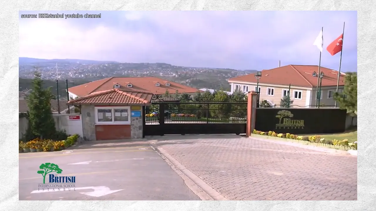 Entrance gate and sign for the British International School Istanbul with flags