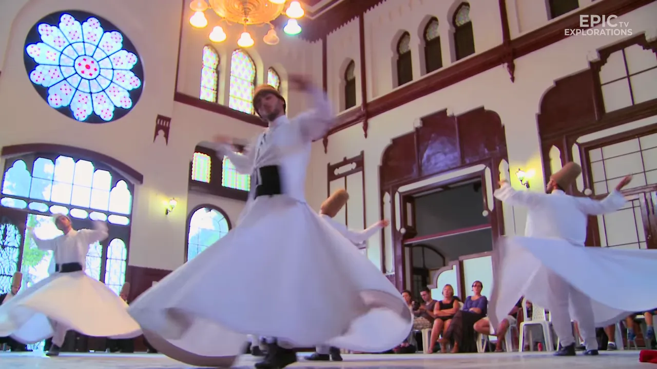 Clear interior shot of a whirling dervish spinning under a rose stained-glass window inside a historic hall