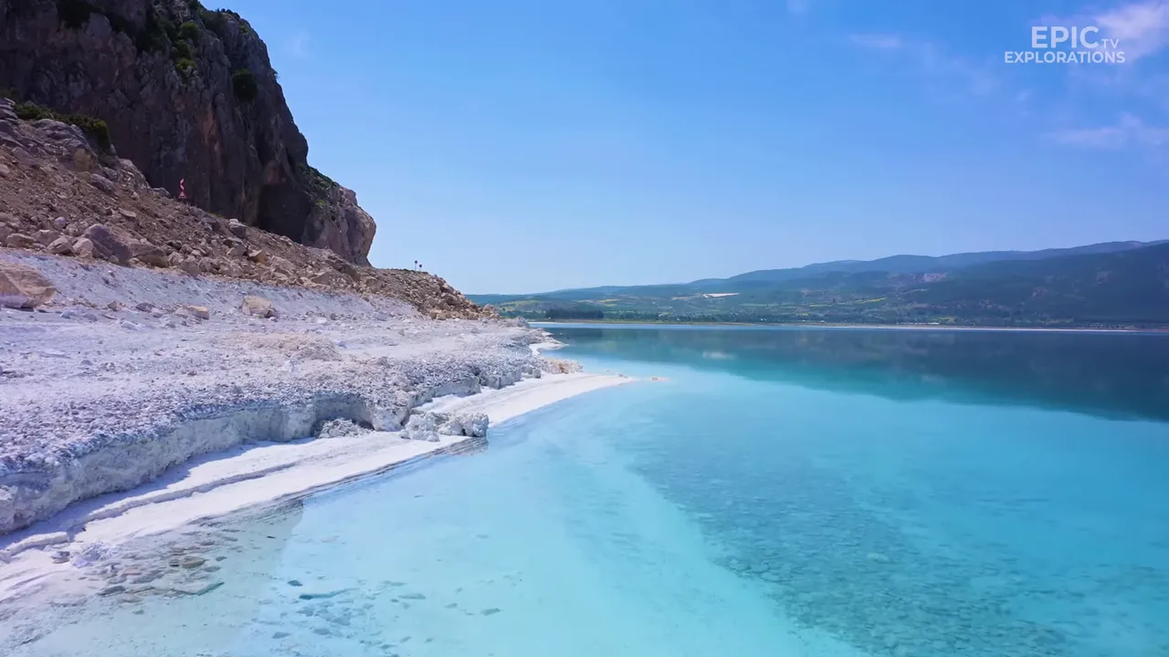 Close view of Lake Salda showing white magnesium-rich shoreline and clear turquoise water.