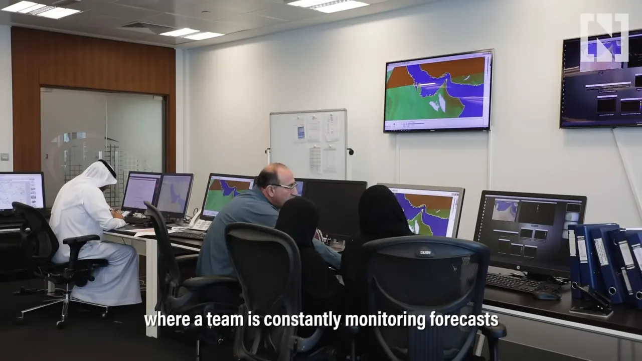 Forecast analysts at computer stations watching regional weather model maps on multiple monitors