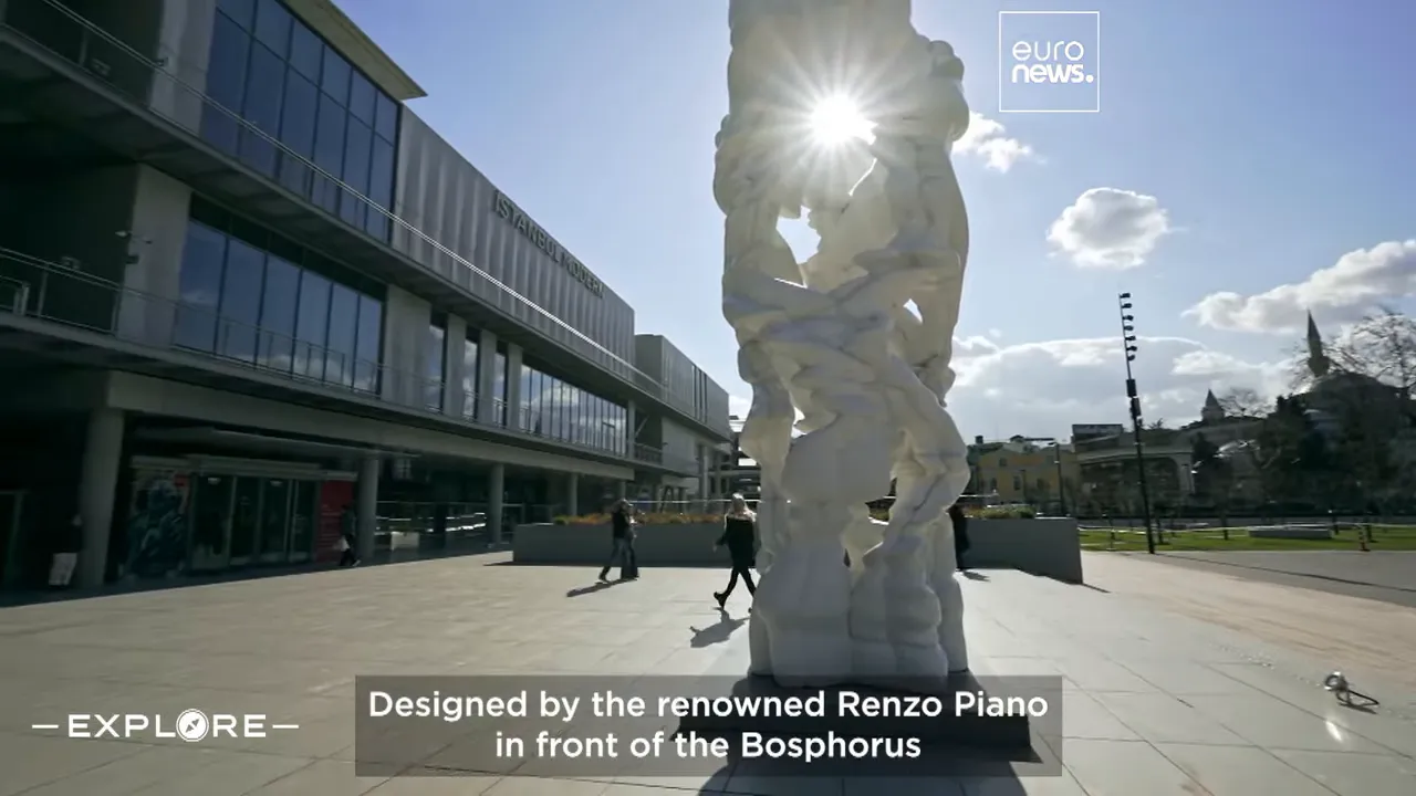 Exterior view of Istanbul Modern museum on the Bosphorus with a large outdoor sculpture and sun glare