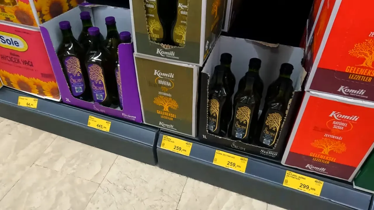 Supermarket shelf showing bottles and boxes of cooking oil with price labels
