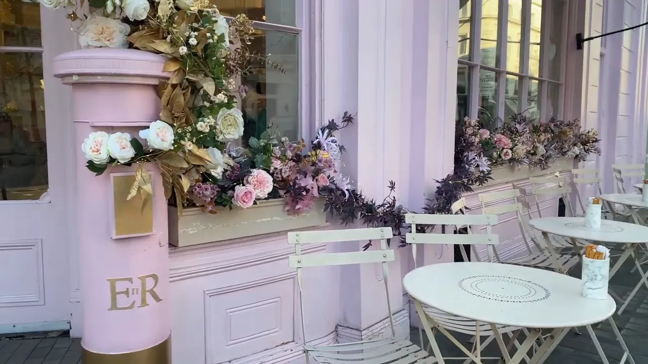 Peggy Porschen Cakes dış mekanında pembe vitrin ve &ccedil;i&ccedil;ek s&uuml;slemeleri