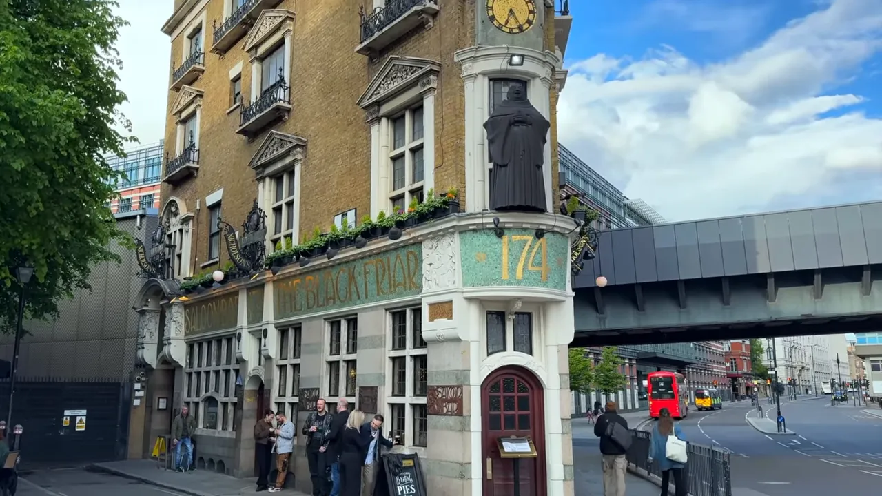 The Blackfriar pub exterior showing an ornate facade, corner statue and patrons gathered outside.