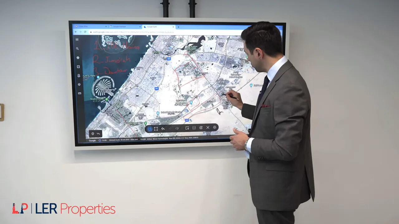 Sunumcu ekranda Dubailand ve City of Arabia civarını kalemle g&ouml;steriyor