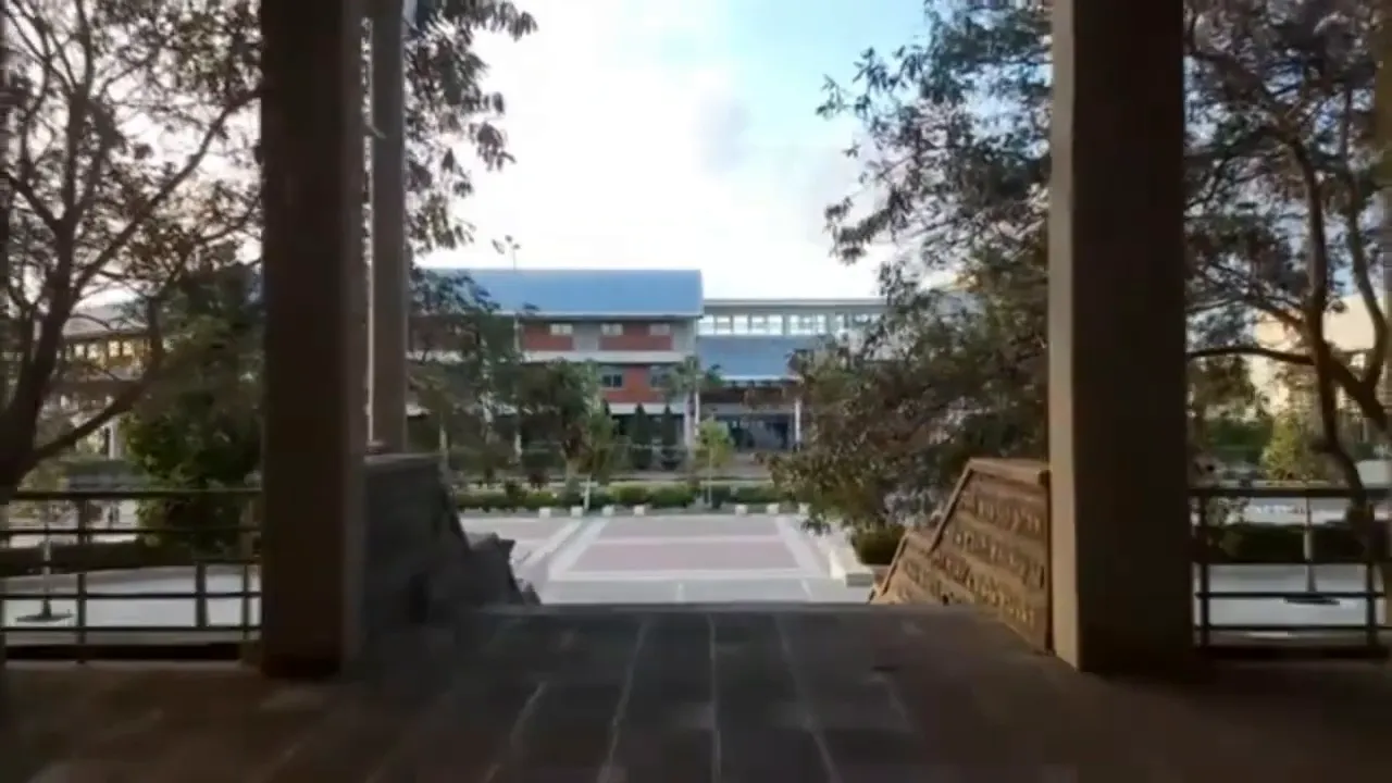view through columns to a central campus plaza and academic buildings