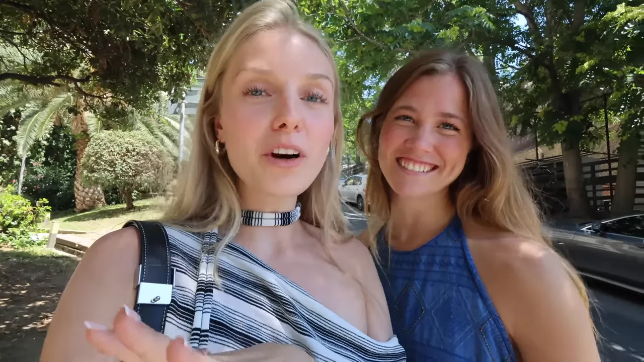 Two friends smiling at the camera under leafy trees in Istanbul