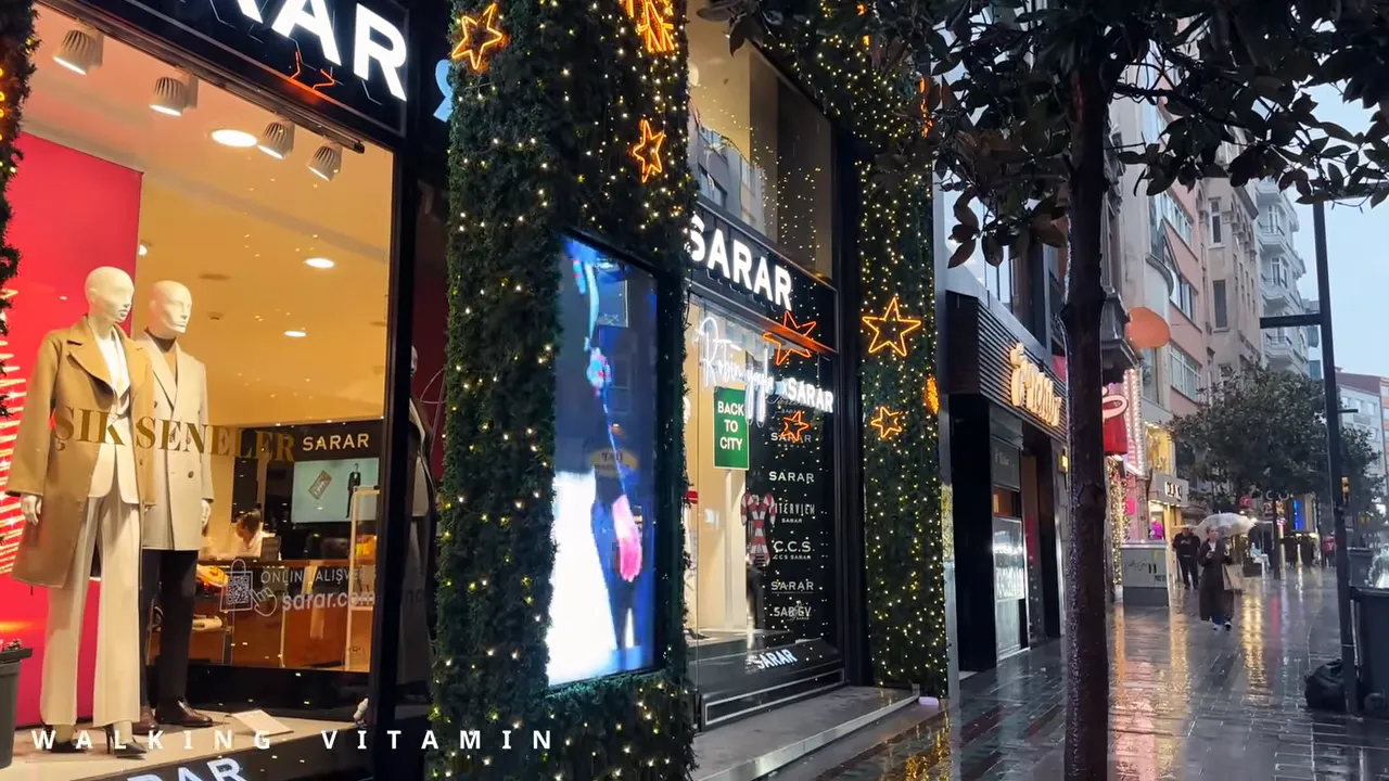 Holiday-lit Sarar storefront with mannequins and wet sidewalk reflections