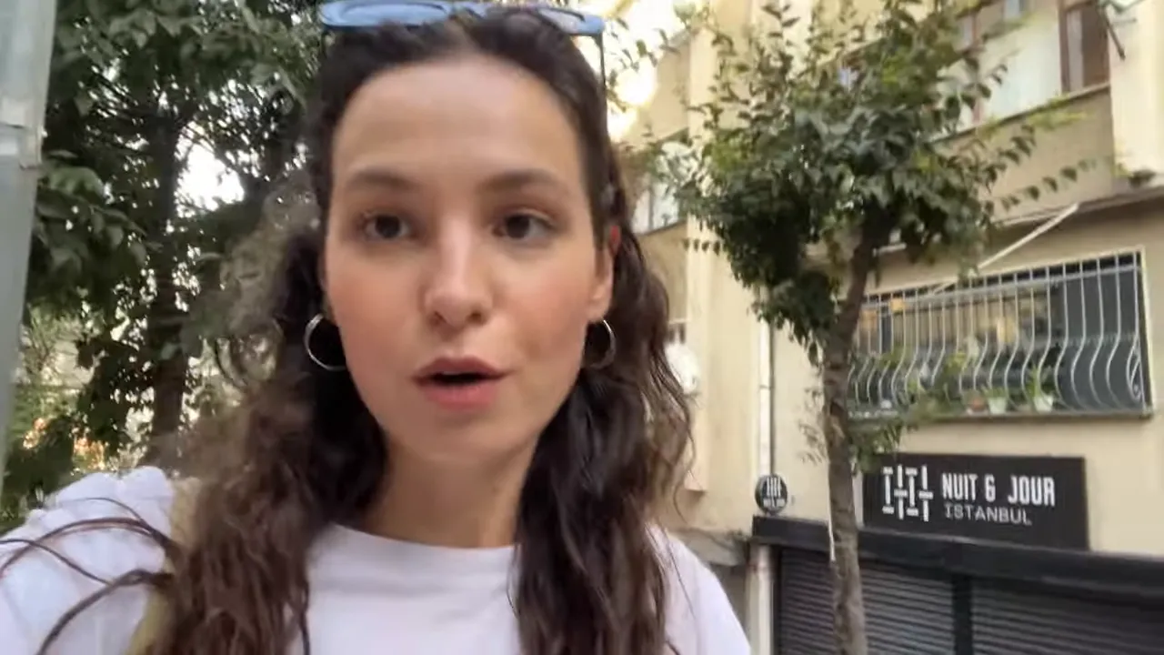 street-level view with a person in foreground and a storefront sign 'Nuit & Jour' with closed shutters behind