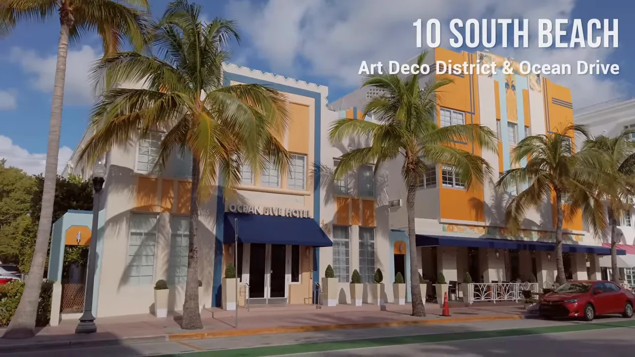 Panoramic view of Ocean Drive showing pastel-colored Art Deco hotels, palm trees and a clear sky