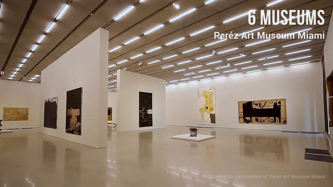 Wide shot of a bright contemporary gallery with artworks on white walls at P&eacute;rez Art Museum Miami