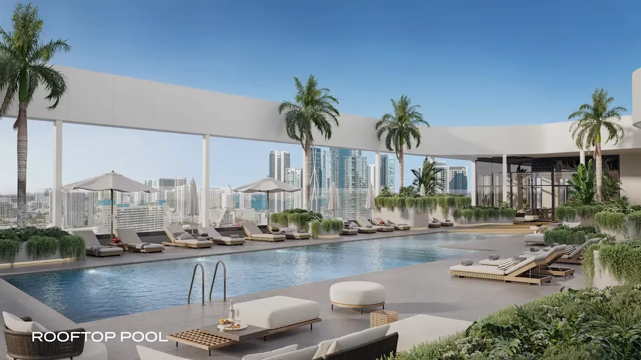 Rooftop pool with lounge chairs and Miami skyline
