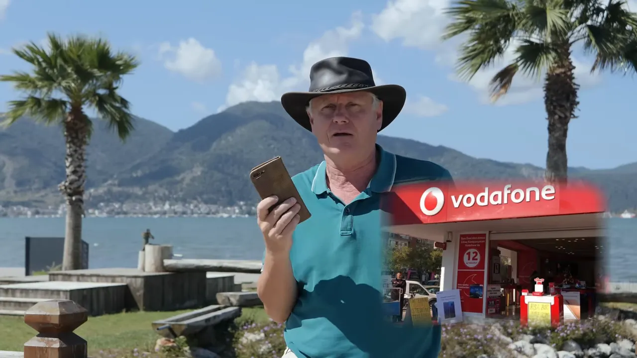 Presenter holding a phone with a clear inset of a Vodafone storefront, illustrating Turkish SIM/provider options