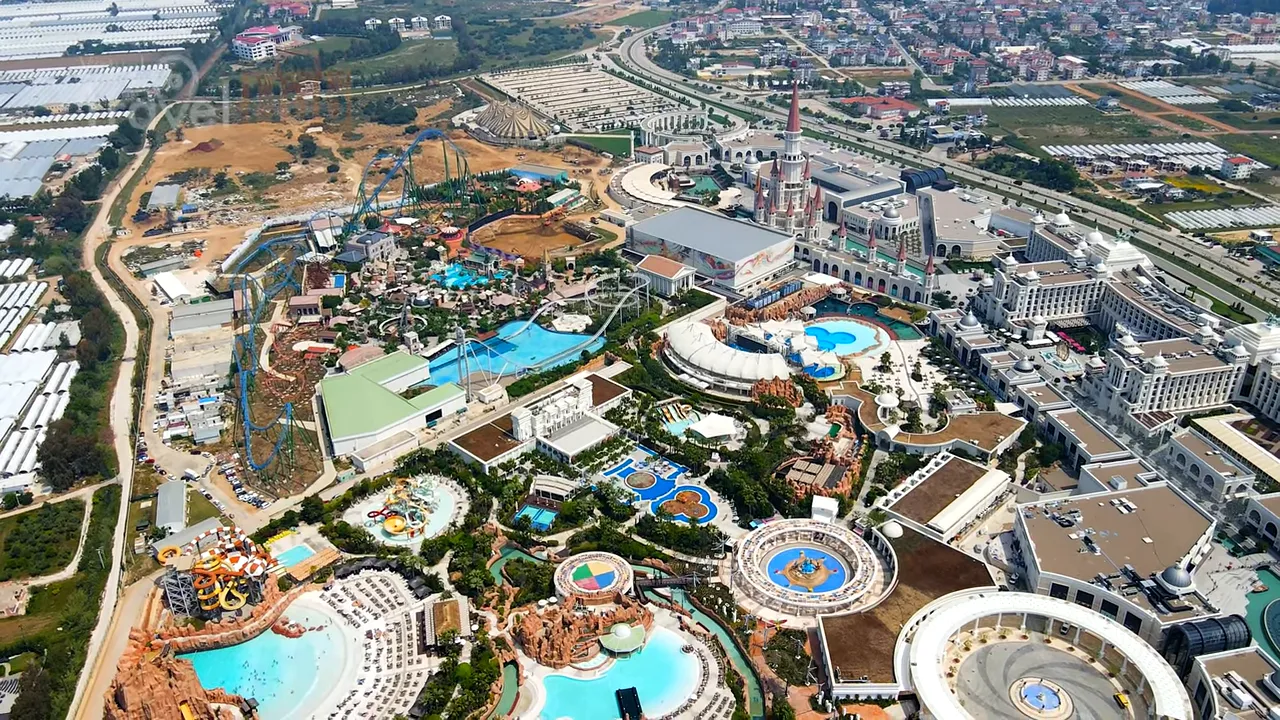 Aerial view of The Land of Legends showing water park pools, roller coasters, shopping mall and hotel complex
