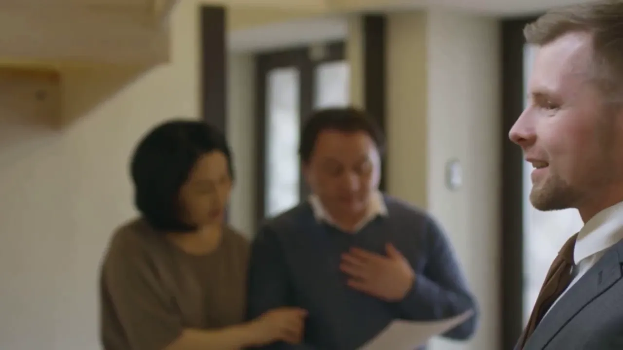 Agent explaining body corporate fees to buyers