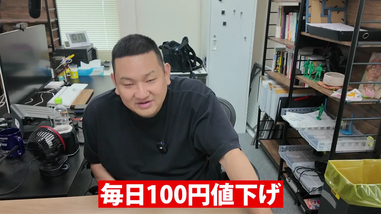 机に座る男性と、毎日100円値下げという赤いテロップ