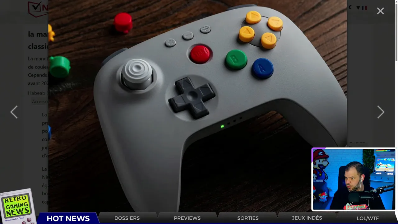 photo nette d'une manette de style n64 avec boutons colorés sur fond bois